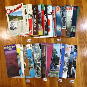 May include: A collection of vintage Oklahoma road maps, organized by decade. The maps are in various colors and feature different designs. The maps are stacked in rows, with the 1950s, 1960s, 1970s, 1980s, 1990s, and 2000s maps labeled below each row.