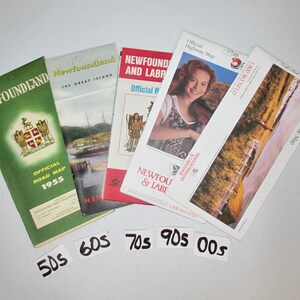 May include: Five vintage road maps of Newfoundland and Labrador, Canada. The maps are from the 1950s, 1960s, 1970s, 1990s, and 2000s. Each map features a different design and includes the text "Newfoundland" or "Newfoundland and Labrador".