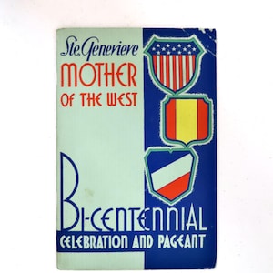 May include: A vintage booklet with a light green and blue design. The cover features text that reads "Ste. Genevieve Mother of the West" and "Bicentennial Celebration and Pageant." Shields with patriotic colors are also displayed.