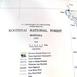 May include: A vintage map of Kootenai National Forest in Montana, from 1955. The map includes a scale in miles, a legend with symbols for various features, and the U.S. Department of Agriculture Forest Service logo.