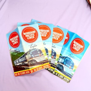 May include: A stack of five vintage travel brochures for the Missouri Pacific Lines, featuring a red and white logo with the text "Missouri Pacific Lines" and a blue and silver train with the text "Eagles" on the cover. The brochures promote the "St. Louis Gateway".