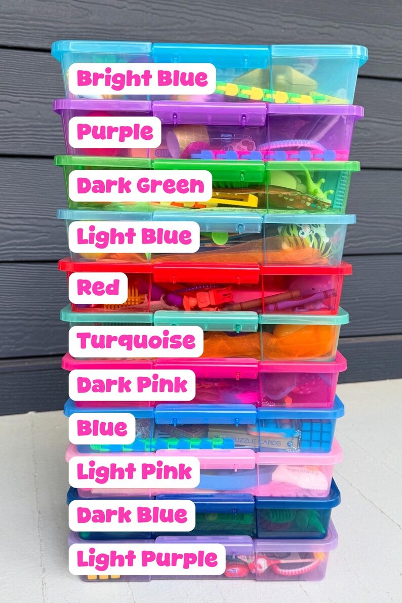 May include: A stack of clear plastic storage bins, each filled with various toys and items. The bins are labeled with the following colors: Bright Blue, Purple, Dark Green, Light Blue, Red, Turquoise, Dark Pink, Blue, Light Pink, Dark Blue, and Light Purple.