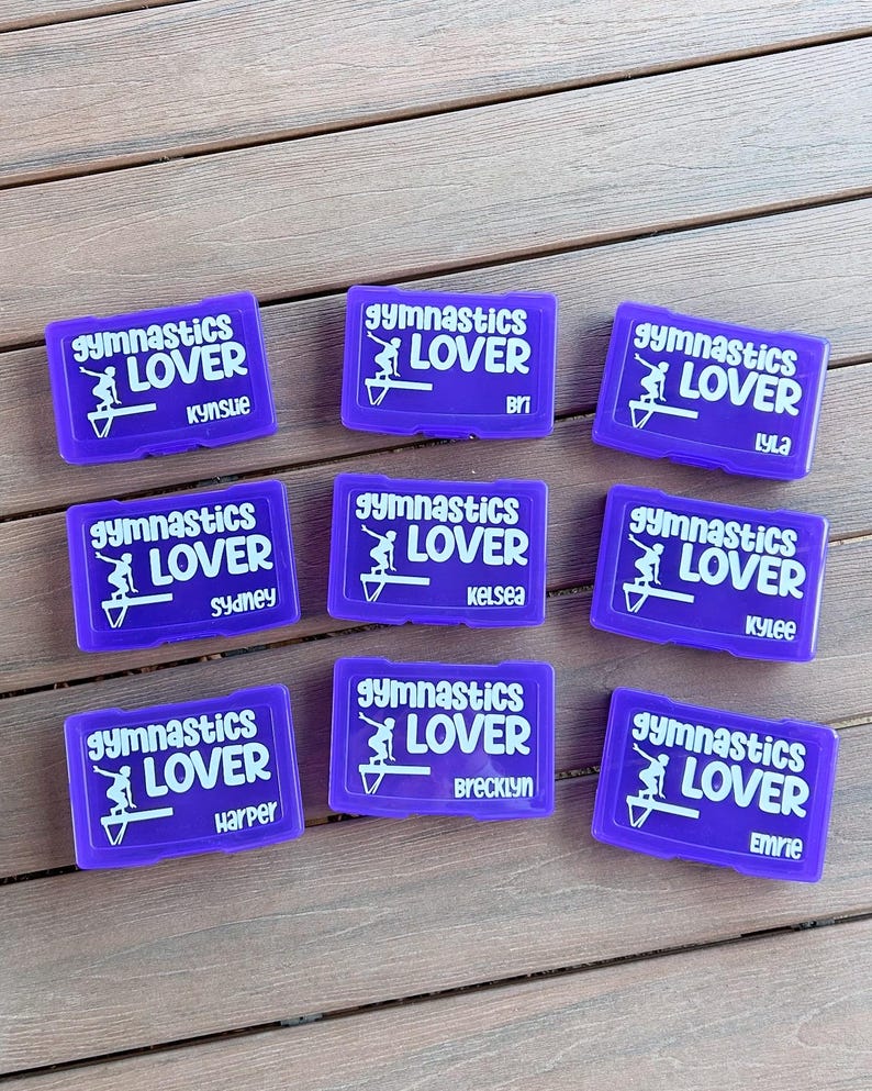 May include: Nine purple rectangular boxes with white text and graphics. Each box reads "Gymnastics Lover" with a gymnast graphic. Each box has a different name: Kynslue, Bri, Lyla, Sydney, Kelsea, Kylee, Harper, Brecklyn, and Emrie.
