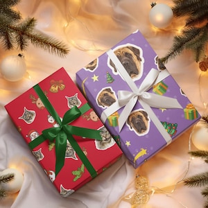 May include: Two wrapped gifts with festive patterns and ribbons. One is red with cat and holiday graphics, tied with a green ribbon. The other is purple with dog faces, tied with a white ribbon. Christmas tree branches and ornaments surround the gifts.