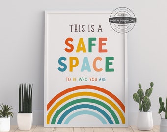 May include: A white framed print with a rainbow arch at the bottom. The text reads "This is a Safe Space to be who you are".