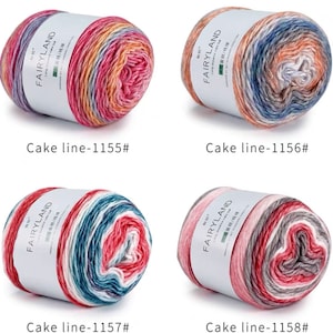 May include: Four balls of yarn in different color combinations. Each ball has a white label with the text "FAIRYLAND" and "Cake line" followed by a number. The yarn colors include red, orange, yellow, blue, gray, and white.