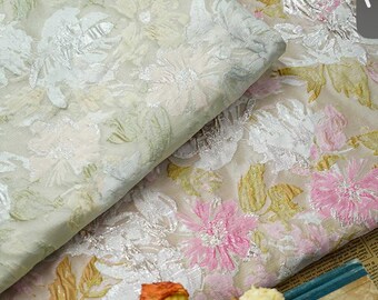 May include: Two pieces of sheer fabric with a floral pattern. The fabric is white with a silver metallic sheen and has a pink and green floral design.