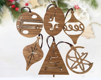 May include: Six wooden Christmas ornaments with various designs, including a star, a tree, a snowflake, and a geometric pattern. The ornaments are all brown and have a rustic look.