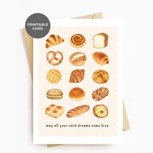 May include: A printable card with a light pink background featuring a variety of illustrated breads and pastries. The text "may all your carb dreams come true" is printed at the bottom of the card.