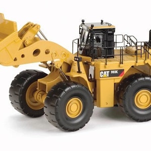 May include: A yellow Caterpillar 993K wheel loader with a large bucket, black tires, and a black cab. The loader has a black ladder on the side and a black safety cage on the back.