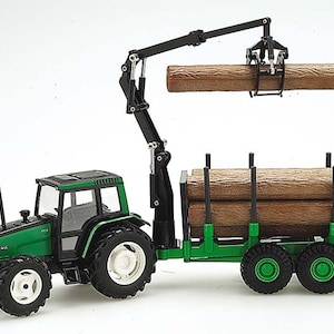 May include: A green and black toy tractor with a crane and a trailer. The crane is lifting a log. The trailer is loaded with logs.
