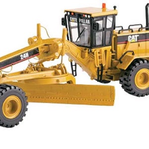 May include: A yellow Caterpillar 24H grader with a black cab and black and yellow markings. The grader has a large blade and a ripper.