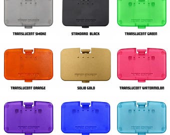 May include: A collection of nine rectangular memory expansion covers in various colors including translucent smoke, standard black, translucent green, orange, watermelon, grape, blue, ice blue, and solid gold. Each cover features the text MEMORY EXPANSION.