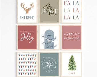May include: Set of nine printable Christmas wall art prints with various designs, including a deer with the text "Oh Deer", a snowflake with the text "Merry Christmas", a Christmas tree with the text "Noel", and a string of lights. The prints are in a variety of colors, including red, green, blue, and white.