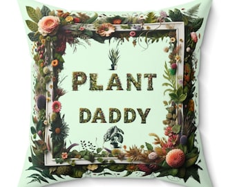 May include: A green cushion with a white frame and the text "Plant Daddy" in green letters. The frame is surrounded by a variety of flowers and plants.