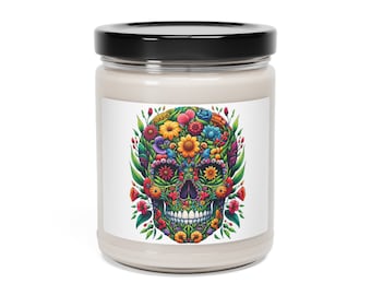 May include: A white candle jar with a black lid and a colourful floral skull design on the label. The skull is made up of flowers and leaves in shades of pink, yellow, orange, green, and blue.