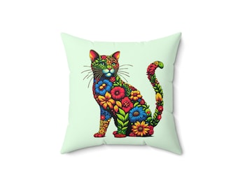 May include: A decorative cushion featuring a colourful floral cat design. The cat is sitting with its tail curled around its body. The flowers are in shades of red, yellow, blue, green and orange.