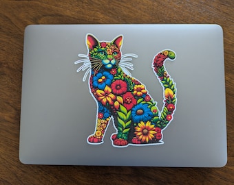 May include: A colourful cat sticker with a floral design. The cat is sitting with its tail curled around its body. The flowers are in shades of red, yellow, blue, green, and orange.
