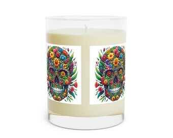 May include: A white candle in a glass jar with a floral skull design on the label. The skull is surrounded by colourful flowers and leaves.
