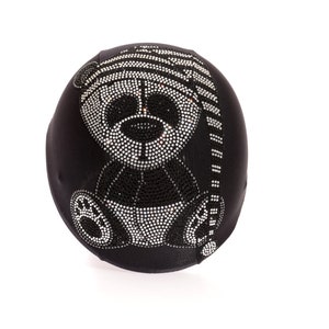 May include: Black fabric helmet with a rhinestone panda bear design wearing a hat. The panda bear is wearing a striped hat.