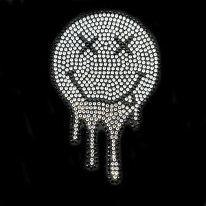 May include: A black and white smiley face with a dripping design made of rhinestones.