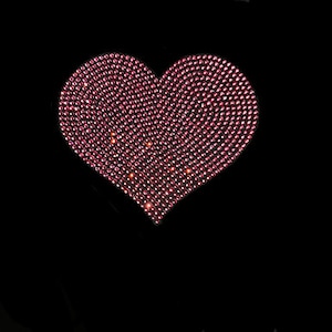 May include: A pink heart-shaped design made of small, sparkling rhinestones.