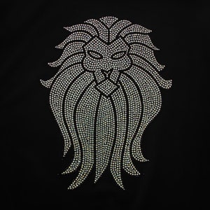 May include: A silver lion's head design made of rhinestones. The design is on a black background.