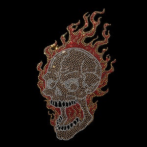 May include: A fiery skull design made of rhinestones in shades of red, orange, and gold. The skull is outlined in clear rhinestones and has a detailed design.