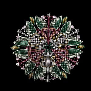 May include: A circular design made of rhinestones in shades of green, white, pink, and gold. The design features a floral pattern with intricate details.