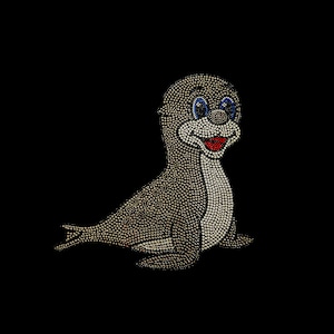 May include: A cartoon seal made of rhinestones. The seal is light brown with blue eyes and a red mouth. It is smiling and has a white belly.