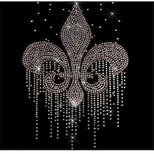May include: A large, silver rhinestone fleur-de-lis design with a dripping effect. The design is made of small, round rhinestones that are arranged in a pattern to create the shape of a fleur-de-lis. The rhinestones are iridescent, giving the design a shimmering effect.