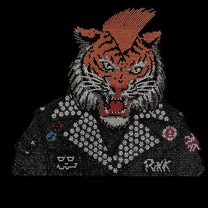 May include: A tiger face made of rhinestones with a black background. The tiger has a red and orange face with a black nose and white whiskers. The tiger is wearing a black jacket with rhinestones and the word "remark" is visible on the jacket.