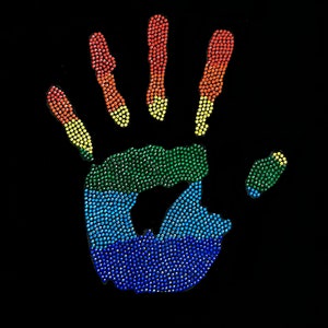 May include: A rainbow handprint made of colorful rhinestones on a black background.