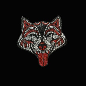 May include: A black, red, and white wolf head design made of rhinestones. The wolf's tongue is sticking out and is also made of rhinestones.