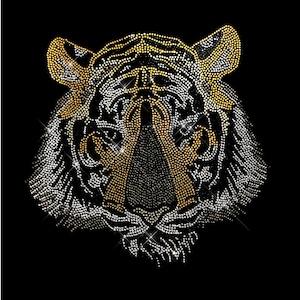 May include: A tiger's face made of rhinestones, with gold and silver rhinestones forming the stripes and details. The tiger's face is looking directly at the viewer.
