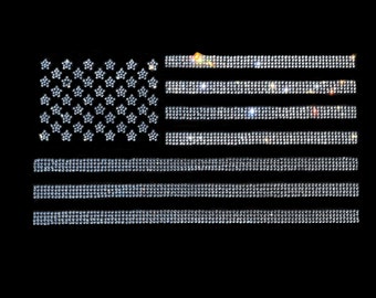 May include: A sparkling American flag made of rhinestones on a black background.
