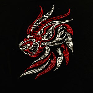 May include: A red and white rhinestone design of a stylized animal head, possibly a lion or wolf, on a black background.