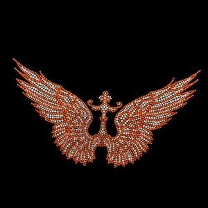 May include: Orange and white rhinestone design of a stylized eagle with wings spread wide. The eagle has a cross in the center of its chest.
