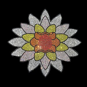May include: A white flower with a yellow and orange centre, made of rhinestones. The flower is a decorative embellishment.