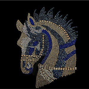 May include: A horse head design made of blue, gold, and white rhinestones. The design is on a black background.