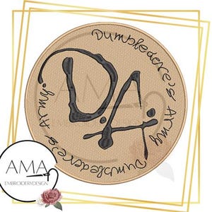 May include: A round, beige embroidery design with black stitching. The design features the text "Dumbledore's Army" written in a circular pattern around the letters "DA".