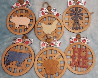 May include: Six wooden ornaments with a farmhouse theme. Each ornament features a different design, including a pig, a chicken, a cow, a windmill, a highland cow, and the word "Home".
