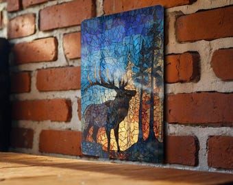 May include: A rectangular metal sign featuring a mosaic-style image of an elk in a forest. The elk is brown and gray, with large antlers. The background has blue, orange, and yellow tones, with trees silhouetted against the light.