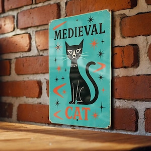 May include: A vintage-style metal sign with a teal background and the words "MEDIEVAL CAT" in black and orange. A black cat with a collar is centered, surrounded by star and boomerang-shaped designs.