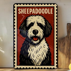 May include: A rectangular metal sign featuring a Sheepadoodle dog illustration. The dog has black and white fur and a red tongue. The sign has a red background with the word "SHEEPADOODLE" in white letters.