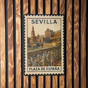 May include: A rectangular sign with a vintage design featuring the text "SEVILLA" at the top and "PLAZA DE ESPAÑA" at the bottom. The image depicts a detailed illustration of a bridge and buildings. The sign is framed with a postage stamp-like border.
