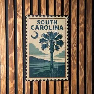 May include: A rectangular sign with a vintage design featuring the text "SOUTH CAROLINA" and a palm tree illustration. The sign has a postage stamp border and is mounted on a wooden slatted wall.