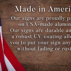 a wooden sign with an american flag on it