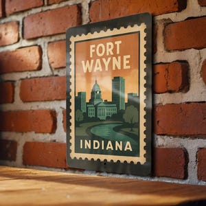 May include: A rectangular metal sign featuring a vintage-style illustration of Fort Wayne, Indiana. The sign has a postage stamp design with the words "FORT WAYNE" and "INDIANA" in white. The image includes a cityscape with a river and a sunset.