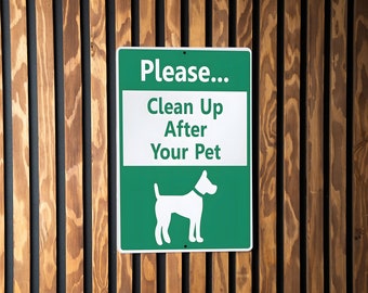 May include: Green sign with white text that reads "Please... Clean Up After Your Pet". A white silhouette of a dog is at the bottom of the sign.